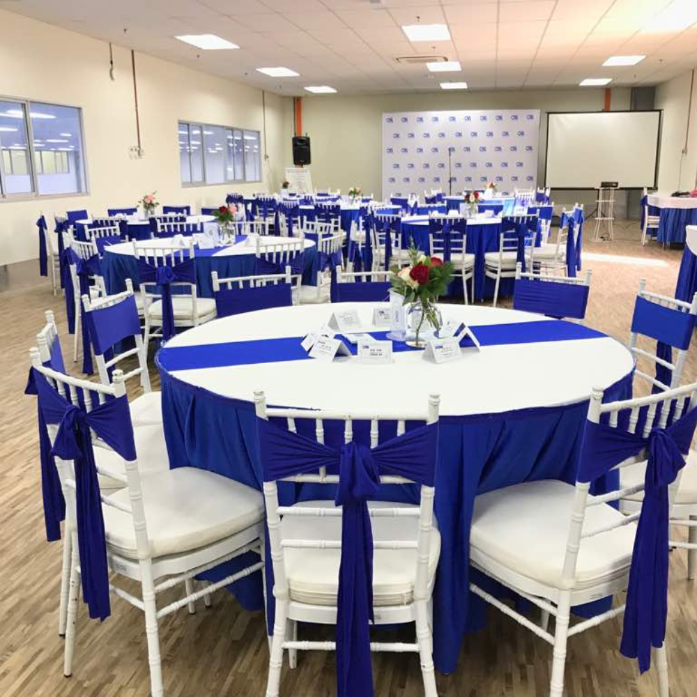 Sharjah — Furniture rental: Banquet Round Tables Blue White Sashes