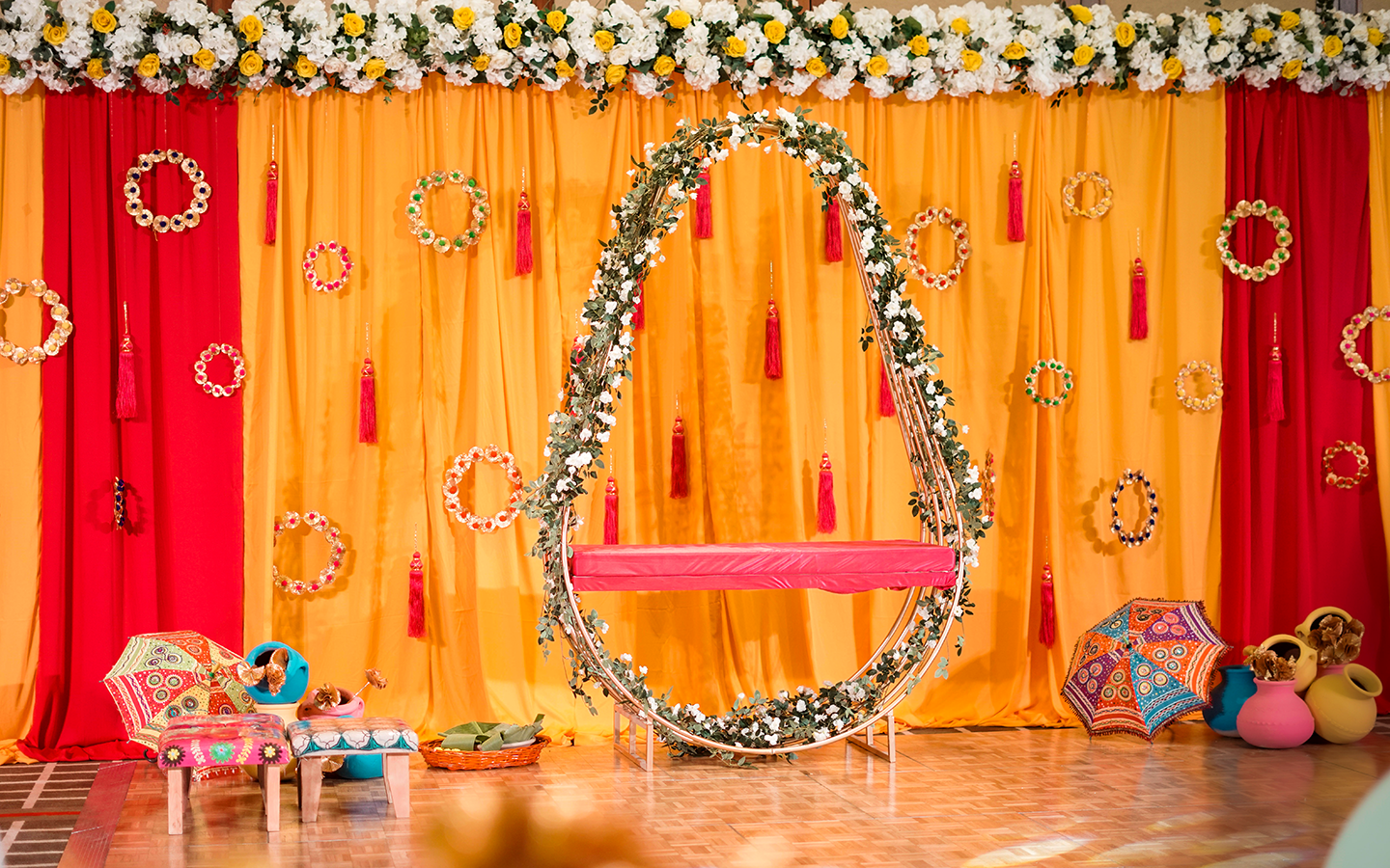 Abu Dhabi — Decorations services: Mehndi Stage Yellow Red Drapes