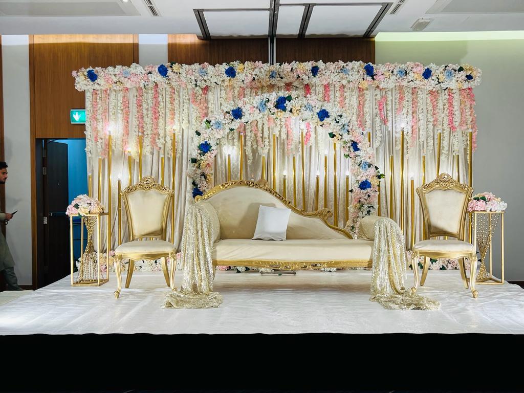 Abu Dhabi — Decorations services: Wedding Stage Gold Sofa Floral Backdrop